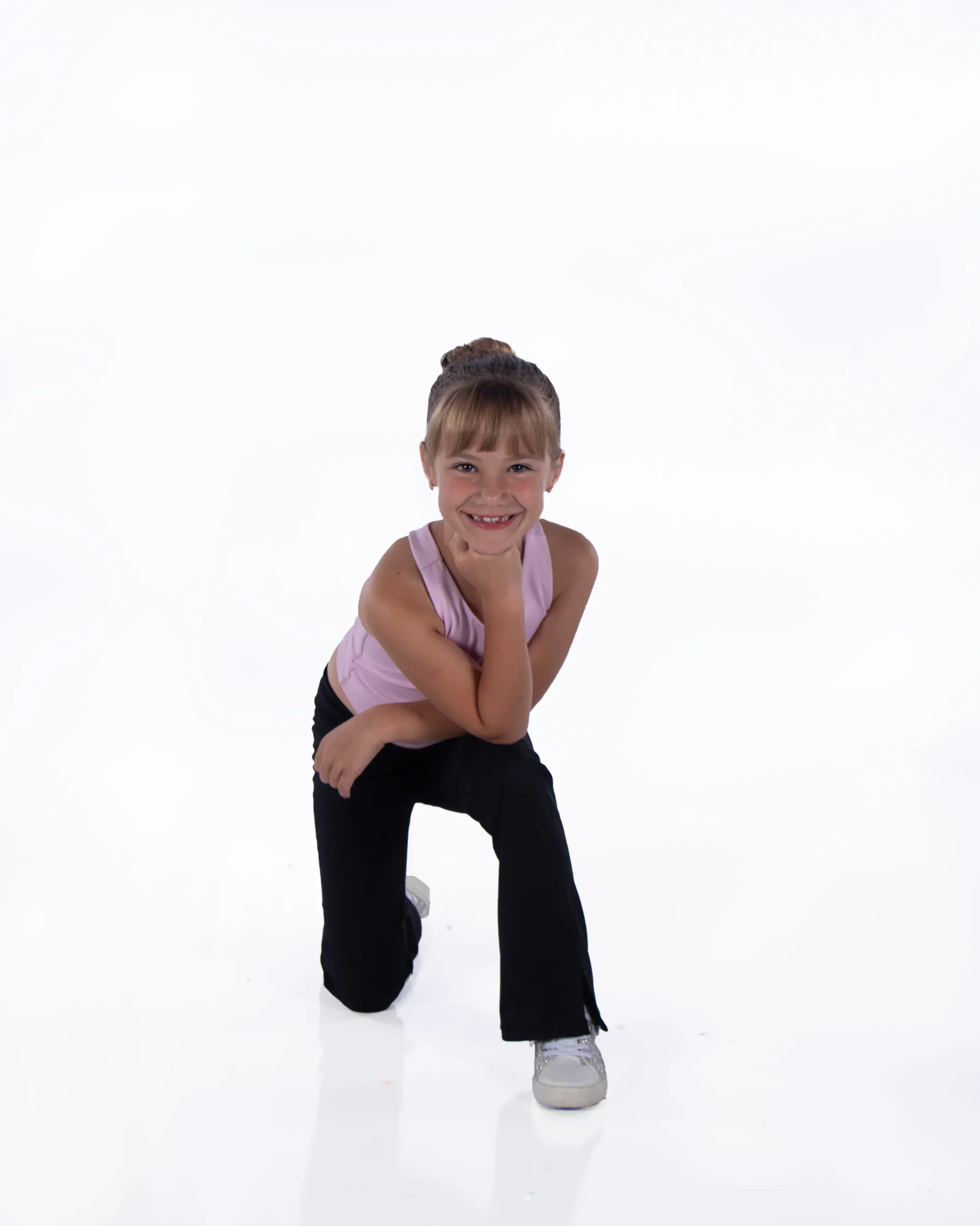 girl-kneeling-smiling-white-background